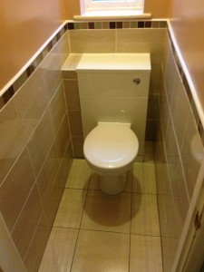Fitted Toilet with tiled walls