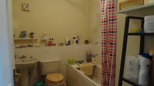 Old Bathroom Suite with tiles falling off the wall