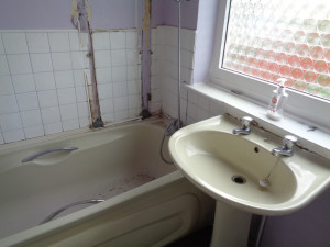 Damaged Bathroom Walls above the Bath