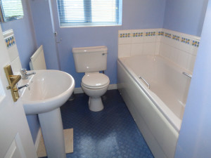 Blue and White Bathroom with White Tiles