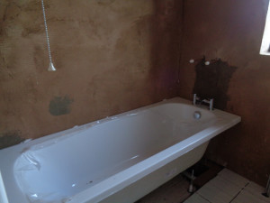 Bath silicon sealed to the bathroom wall creating a first seal