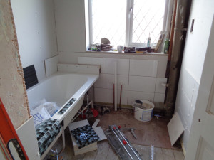 Bathroom walls plaster boarded and bath fitted and silicon sealed