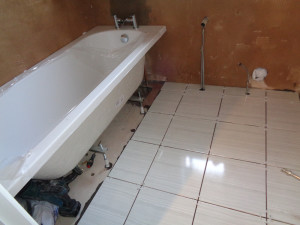 Bathroom Floor Tiled, the hot and cold water pipes chrome