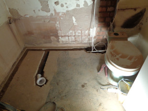Bathroom concrete floor channeled out for water pipes