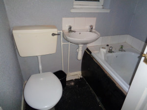 The original bathroom with water and waste pipes showing