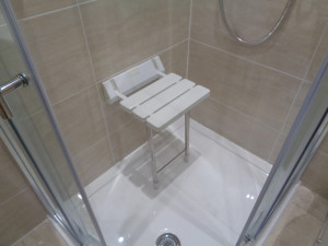 Shower with Wall mounted shower chair and safety grab rails