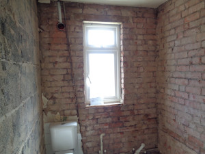 Bathroom suite and tiles removed back to brick