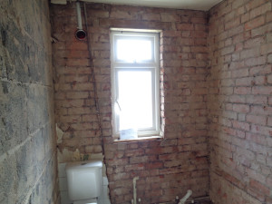 Bathroom suite and tiles removed back to brick