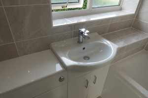 Wall to Wall Vanity Fitted Furniture Finished With boxed Tile area Above Bath  