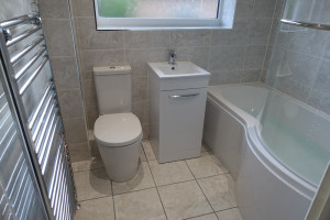 Modern toilet, 30cm wide vanity basin and P shaped shower bath