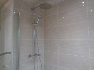 Wall mounted thermostatic shower running of the hot water boiler