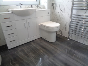 Black Marble Bathroom Floor with Chrome Towel Warmer and White Bathroom Marble Tiles