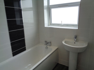 Kaldewei bath fitted in bathroom with white Brighton wall tiles and black feature tile panel