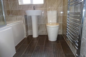 Bathroom with wood effect ceramic tiles of the floor