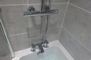 Bath fitted with wall exposed Chrome thermostatic shower