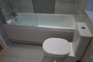 Bathroom with fitted straight bath and modern toilet