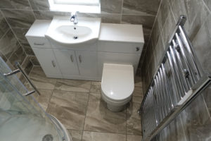 Fitted shower room with chrome towel warmer