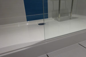 Low level mobility stone resin shower tray