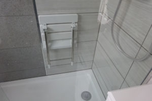 Mobility walk in shower with wall mounted shower seat