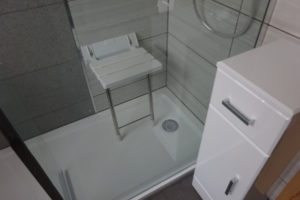 Mobility Bathroom with wall mounted shower seat open