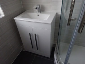 Shower room with fitted vanity basin and shower enclosure