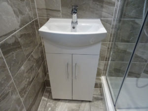 Shower room with storage vanity basin in Coventry