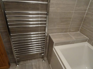 Bathroom fitted with large warm towel warmner