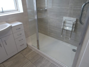 Mobility Shower with fixed glass enclosure and open swivel panel