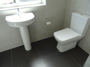 Bathroom with fitted pedestal basin and close coupled toilet