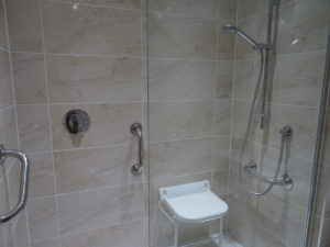 Mobility Shower with remote shower and hand rails