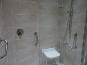 Mobility Shower with remote shower and hand rails