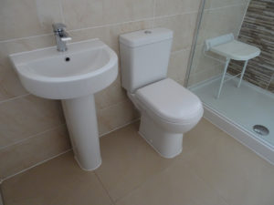 Mobility bathroom with comfort height toilet and basin