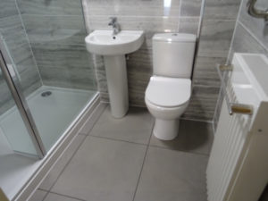 Mobility bathroom with comfort height toilet pan