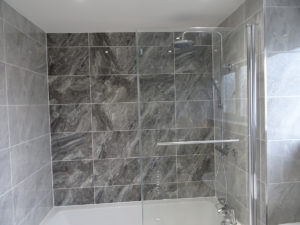 Fully Tiled Bathroom with Feature Tiled Bath Wall