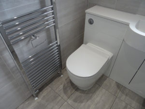 Modern Bathroom Fitted In Coventry with combined vanity toilet and chrome towel warmer