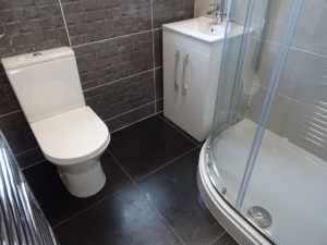 Shower room in small bathroom in Coventry fully tiled