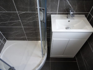 Shower Room fitted with a white vanity basin