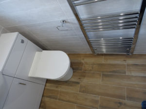 Bathroom fitted in Coventry with chrome towel warmer and fully tiled