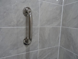 Mobility bathroom with grab rails in the shower area