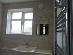 Mobility shower room Coventry fully tiled with wall mounted mirror