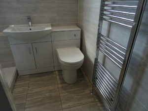 Mobility shower room Coventry with chrome towel warmer
